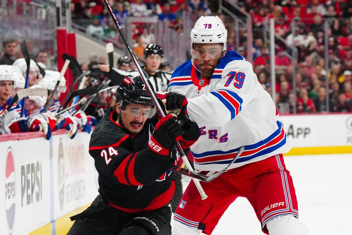 Nov 27, 2024; Raleigh, North Carolina, USA; New York Rangers defenseman K’Andre Miller (79) go after the puck Carolina Hurricanes center Seth Jarvis (24) during the first period at Lenovo Center. James Guillory-Imagn Images