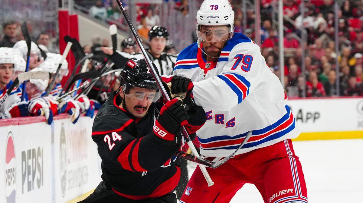 New York Rangers defenseman K’Andre Miller (79) go after the puck Carolina Hurricanes center Seth Jarvis (24) during the first period at Lenovo Center.
