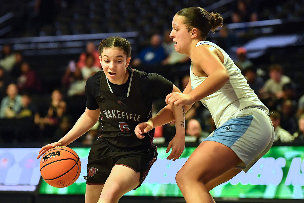 Wakefield’s Heaven Briggs (5) drives to the lane against Hoggard’s AK Chance (32) during the first half. The Wakefield Wolverines and the Hoggard Vikings met in the NCHSAA 4A East Regional Final in Winston-Salem, N.C. on March 12, 2025. Wakefield wins 31-23.