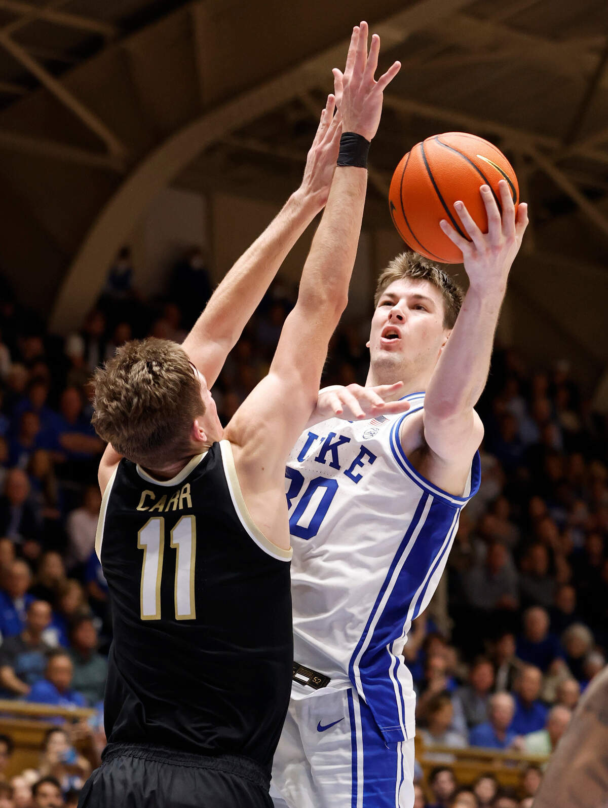 Duke’s Kyle Filipowski (30) drives to the basket past Wake Forest’s Andrew Carr (11) during the second half of Duke’s 75-73 victory over Wake Forest at Cameron Indoor Stadium in Durham, N.C., Tuesday, Jan. 31, 2023.