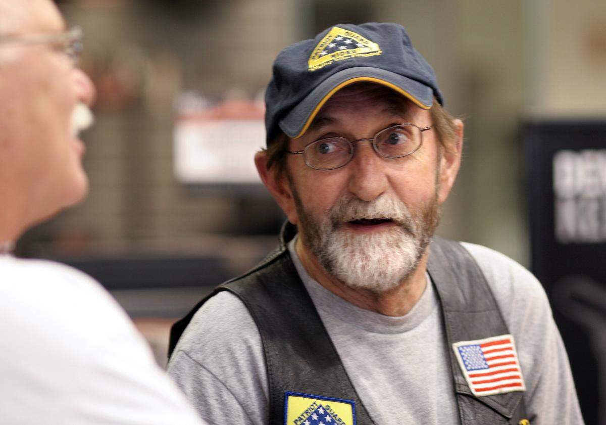 Dennis Rogers relaxes with his friends at Ray Price Harley-Davidson in Raleigh Saturday, June 2, 2007.