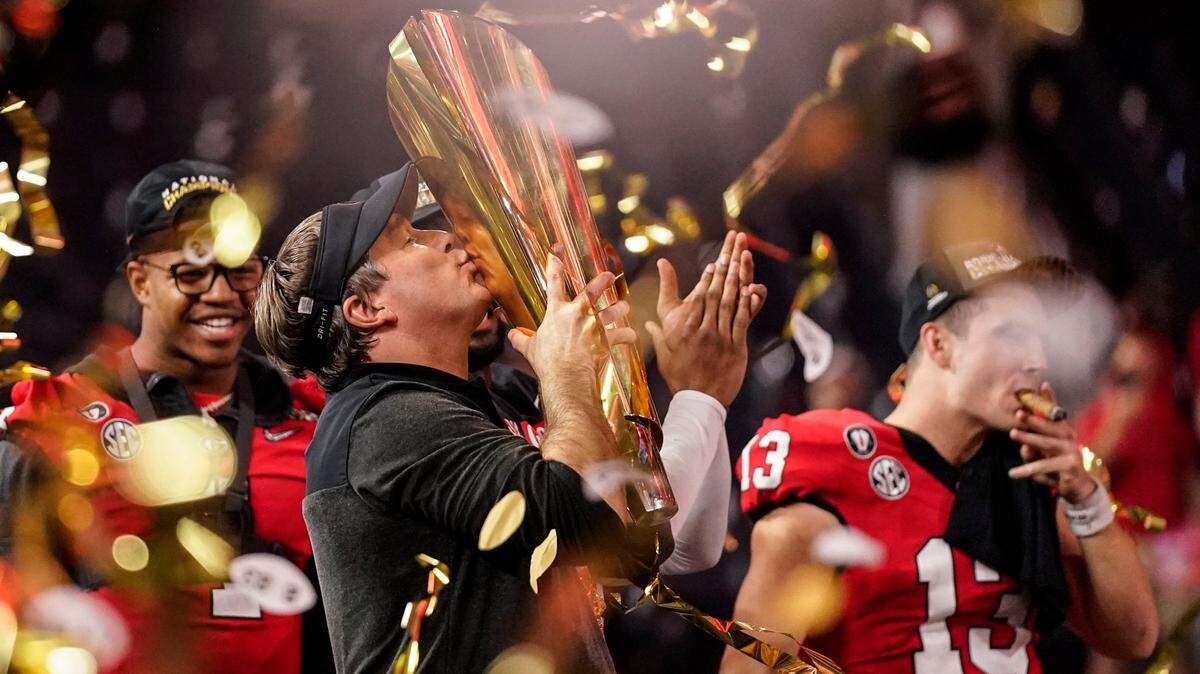 Georgia head coach Kirby Smart kisses the championship trophy after the national championship NCAA College Football Playoff game against TCU, Monday, Jan. 9, 2023, in Inglewood, Calif. Georgia won 65-7.