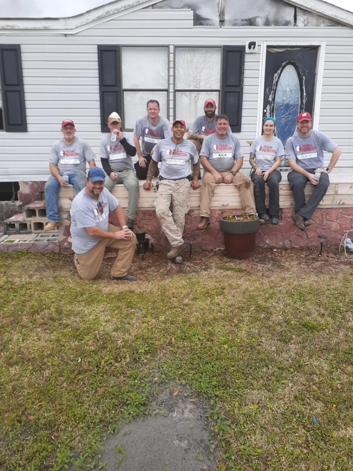 A volunteer group poses for a group picture outside Arlisha Hill’s home in Maple Hill, N.C.