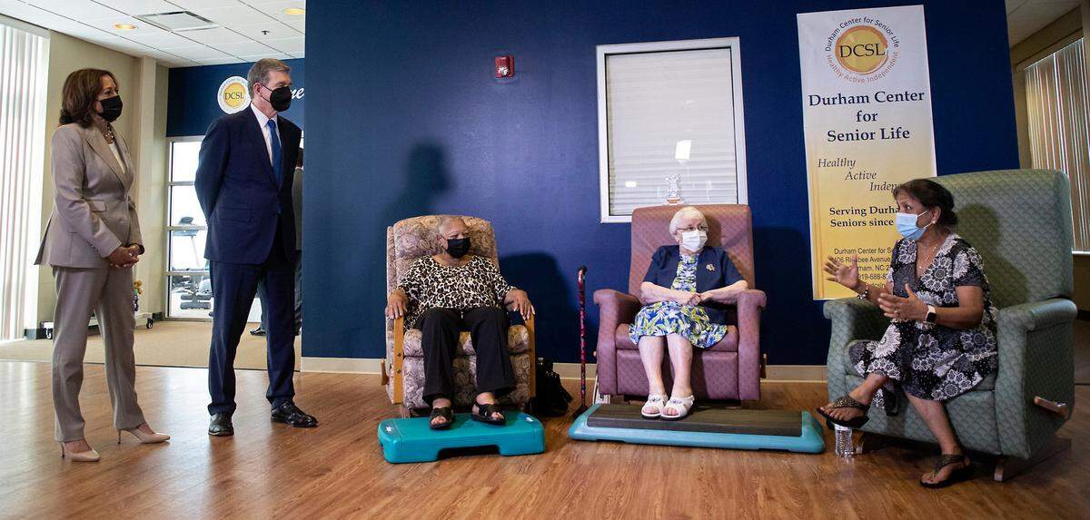 Vice President Kamala Harris and North Carolina Gov. Roy Cooper listen during a tour of the Durham Center for Senior Life on Thursday, Sept. 1, 2022, in Durham, N.C.