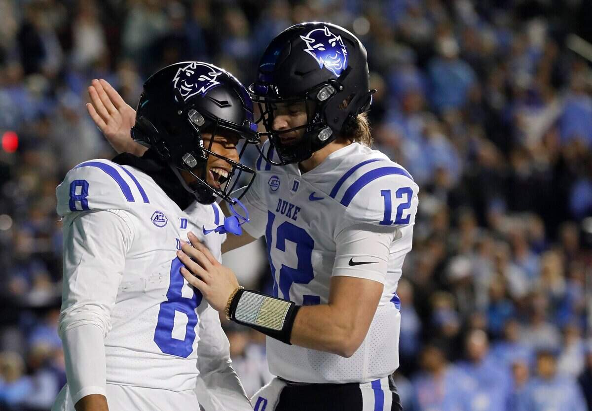 Duke’s Jordan Moore is congratulated by teammate Grayson Loftis after he scored a touchdown during the first half of the Blue Devils’ game against North Carolina on Saturday, Nov. 11, 2023, at Kenan Stadium in Chapel Hill, N.C.