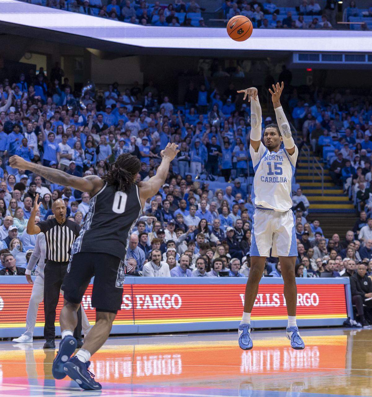 North Carolina forward Jarin Stevenson (15) connects for a 3-point basket against Georgetown forward Jayden Fort (0) on Dec. 7.