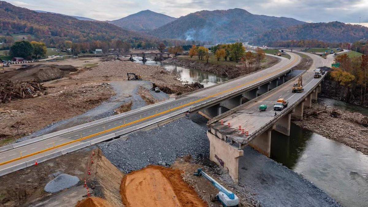 Interstate 26 reopened to traffic between North Carolina and Tennessee on Oct. 30, 2024. Traffic is reduced to one lane in each direction where I-26 crosses the Nolichucky River in Erwin, Tennessee, about 40 miles from the state line, while contractors replace a bridge span that collapsed during Hurricane Helene.