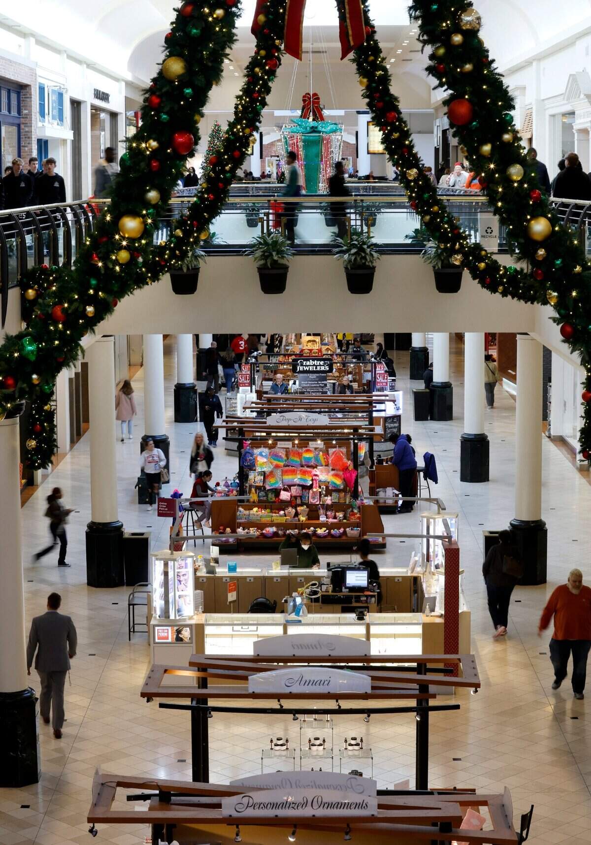 Shoppers walk through Crabtree Valley Mall in Raleigh, N.C., Friday, Nov. 18, 2022.