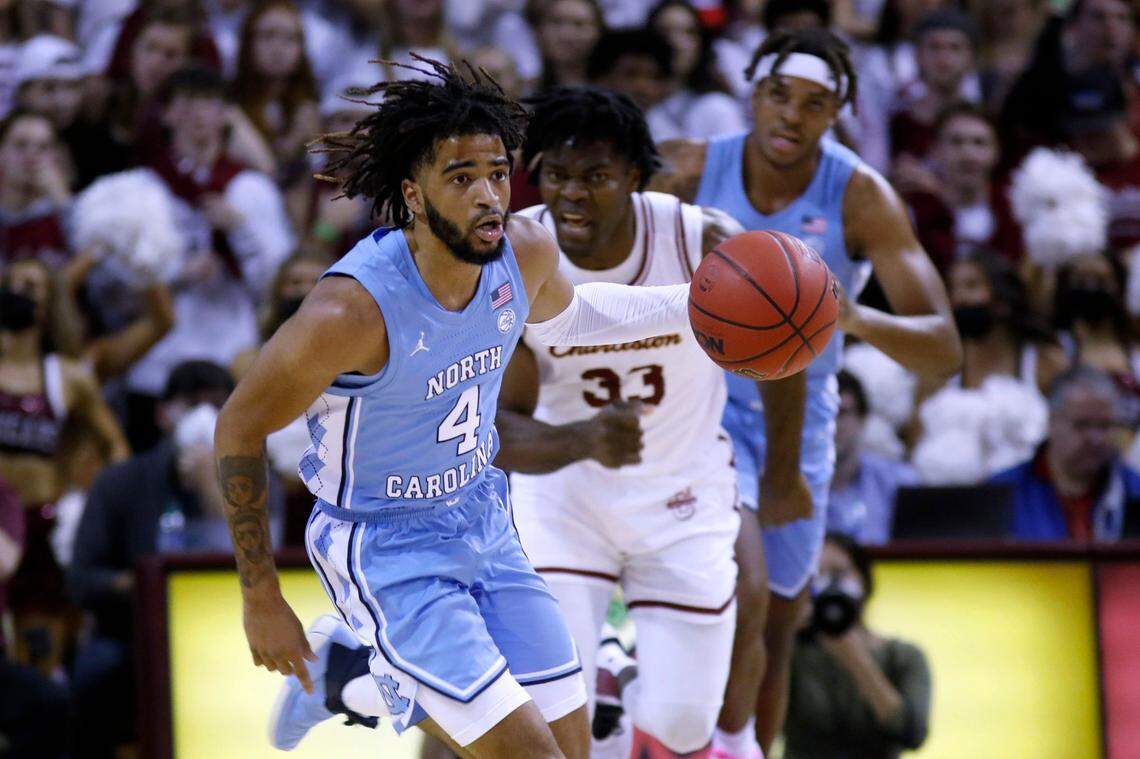 North Carolina’s RJ Davis (4) brings the ball up as College of Charleston’s Osinachi Smart (33) trails during the first half of an NCAA college basketball game Tuesday, Nov. 16, 2021, in Charleston, S.C. (AP Photo/Mic Smith)