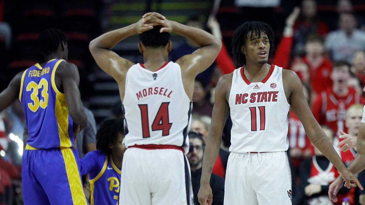 N.C. State’s Casey Morsell and Dennis Parker Jr. react to a foul called against the Wolfpack during the second half of the team’s 67-64 loss to Pittsburgh on Wednesday, Feb. 7, 2024, at PNC Arena in Raleigh, N.C.