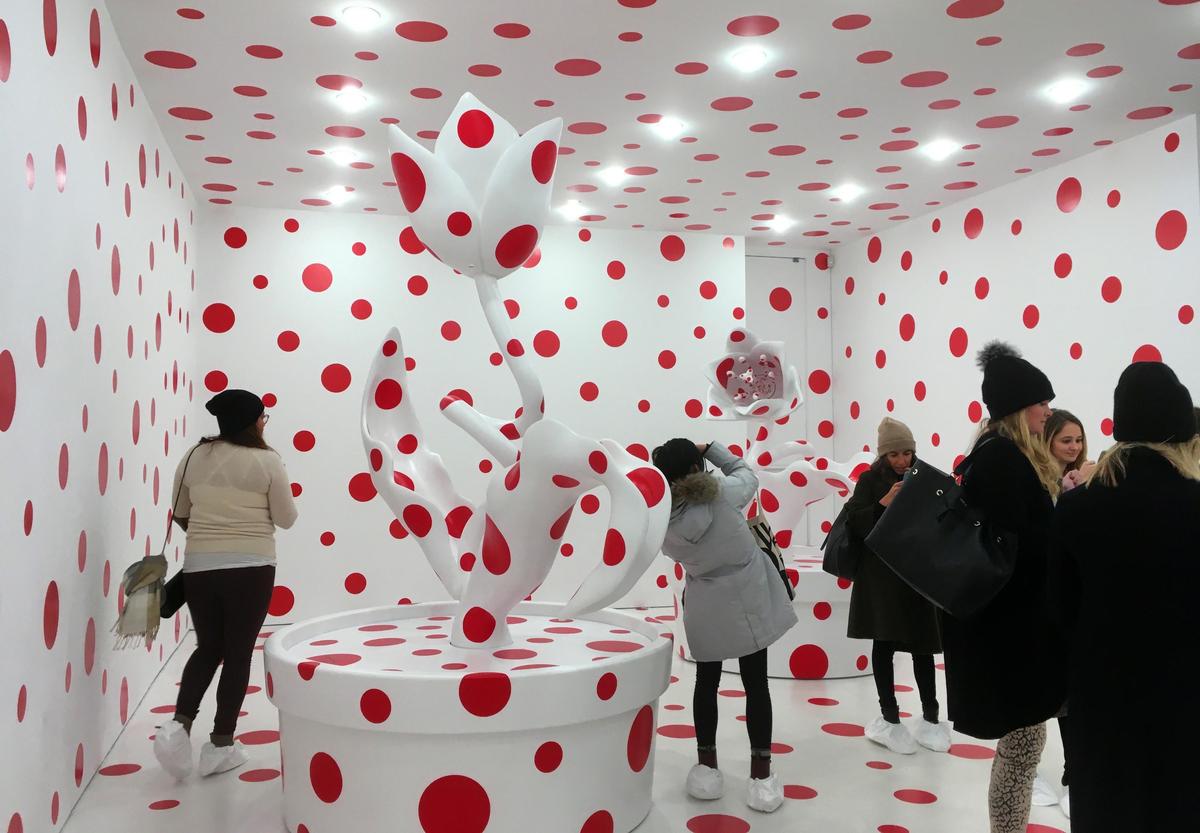 In this Nov. 21, 2017 photo, people view a polka-dotted room created by Japanese artist Yayoi Kusama, part of the exhibit, "Yayoi Kusama: Festival of Life," on display at the David Zwirner gallery in the Chelsea section of New York.