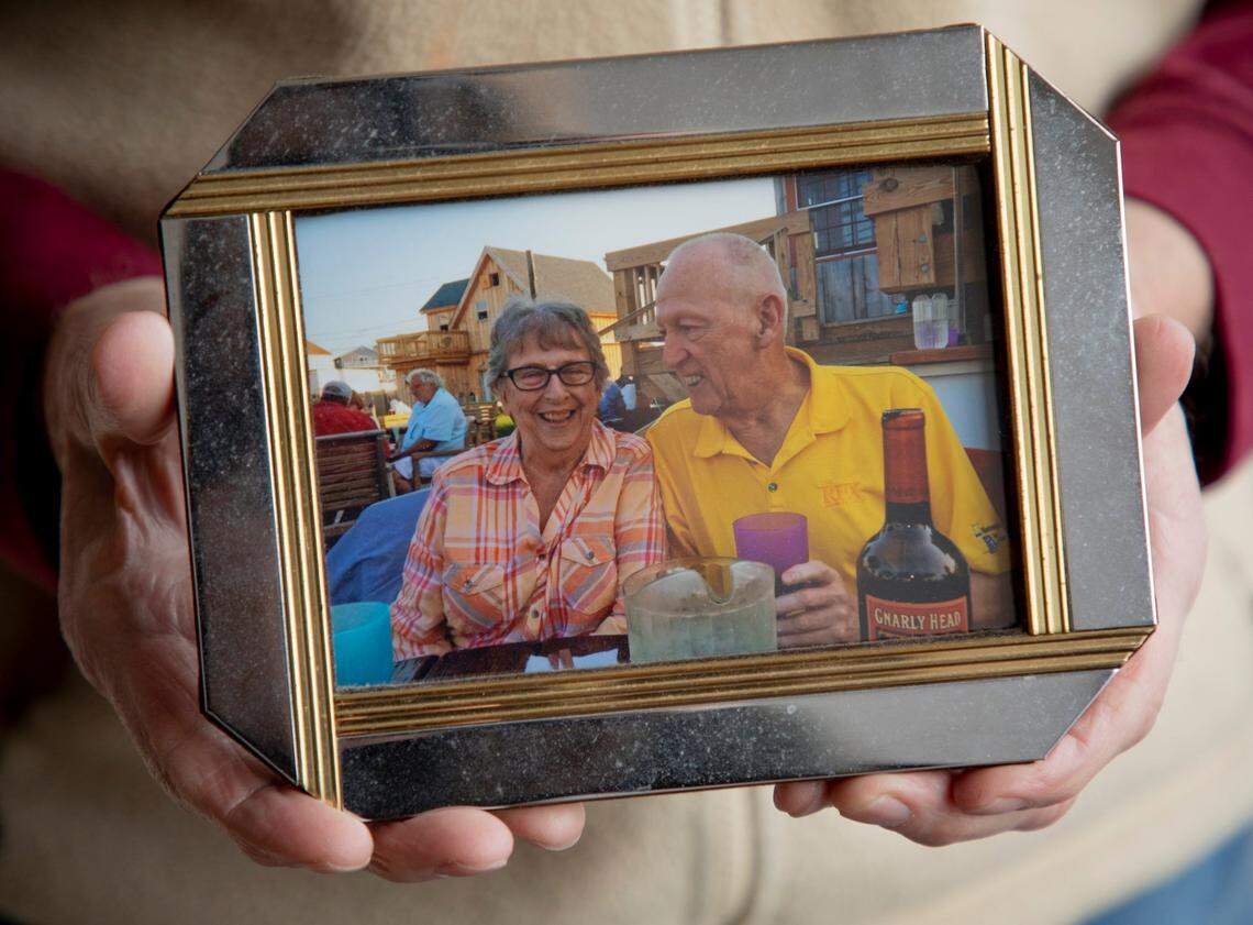 Albert Robinson holds a photograph of himself together with his late wife, on Tuesday, Mar. 2, 2021, in Raleigh, N.C.