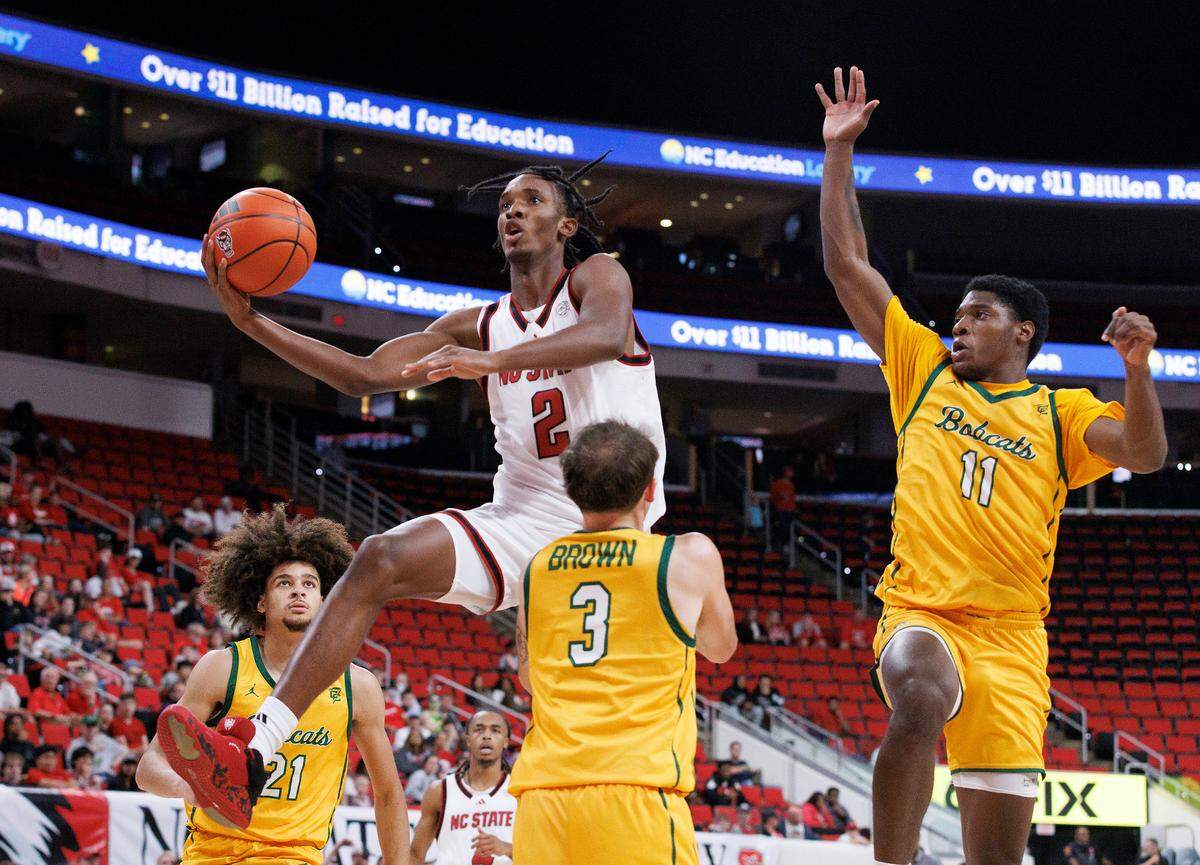 N.C. State’s Paul McNeil, Jr. drives to the basket past Lees-McRae’s Brandon Brown (3) during the first half of the Wolfpack’s exhibition game on Wednesday, Oct. 30, 2024, at the Lenovo Center.