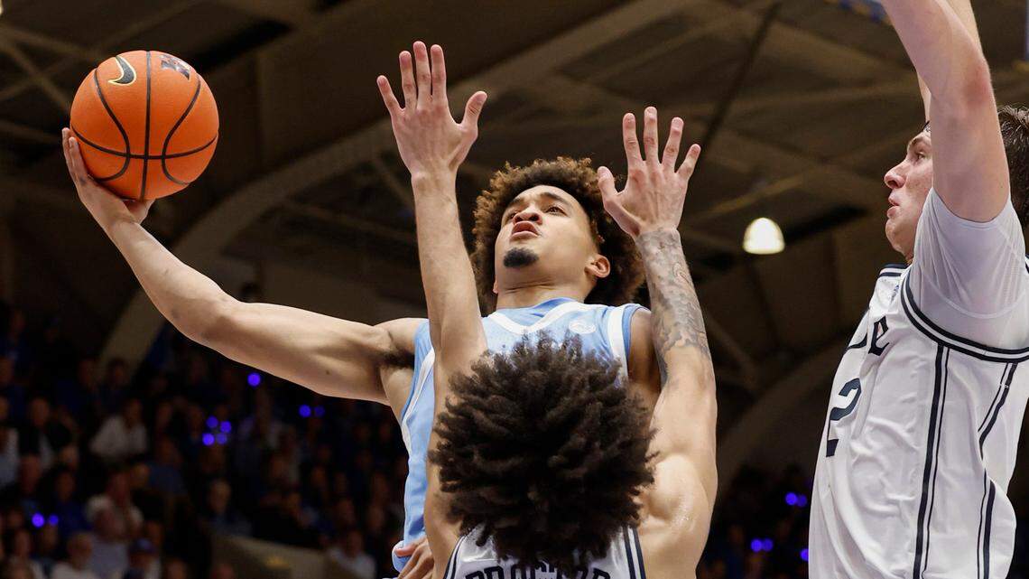 North Carolina’s Seth Trimble (7) goes up to the basket as Duke’s Tyrese Proctor (5) defends during the first half of Duke’s game against UNC at Cameron Indoor Stadium in Durham, N.C., Saturday, Feb. 1, 2025.