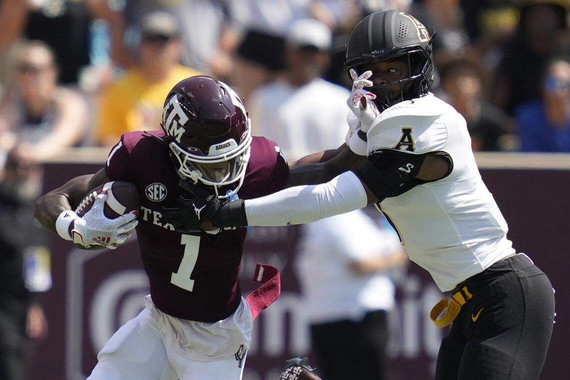 Texas A&M wide receiver Evan Stewart (1) tries to fight off a tackle by Appalachian State linebacker Trey Cobb (7) during the first quarter of an NCAA college football game Saturday, Sept. 10, 2022, in College Station, Texas.