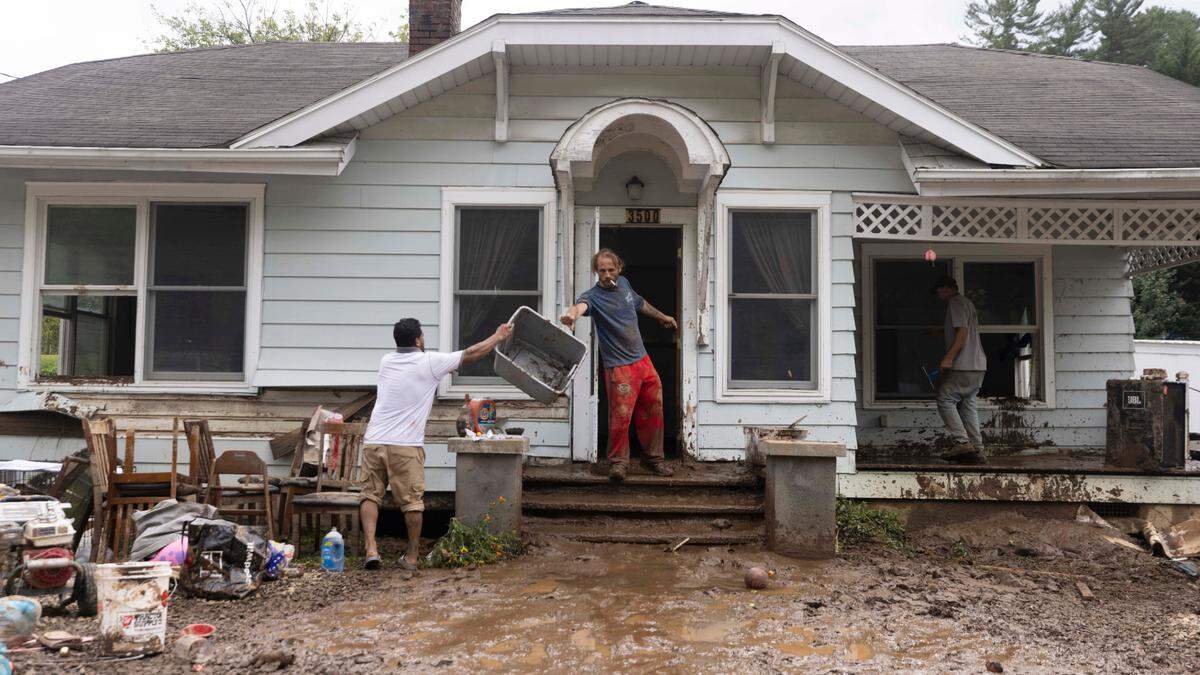 Residents in Clyde begin cleaning up on Saturday, Sept. 28, 2024 after massive flooding damaged dozens of homes and businesses. The remnants of Hurricane Helene caused widespread flooding, downed trees, and power outages in western North Carolina.