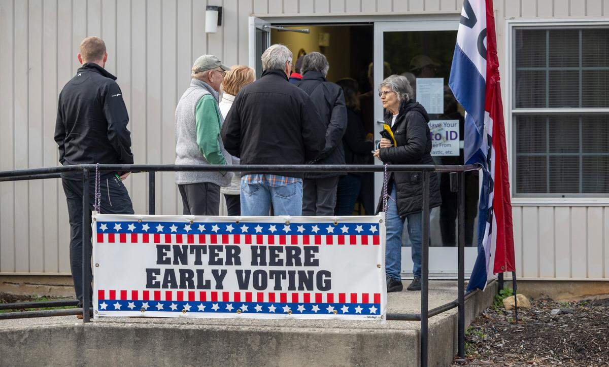 Voters wait in line to cast their ballots at the Haywood County Senior Resource Center, on the first day of early voting, in Waynesville, N.C. on Thursday, October 17, 2024.