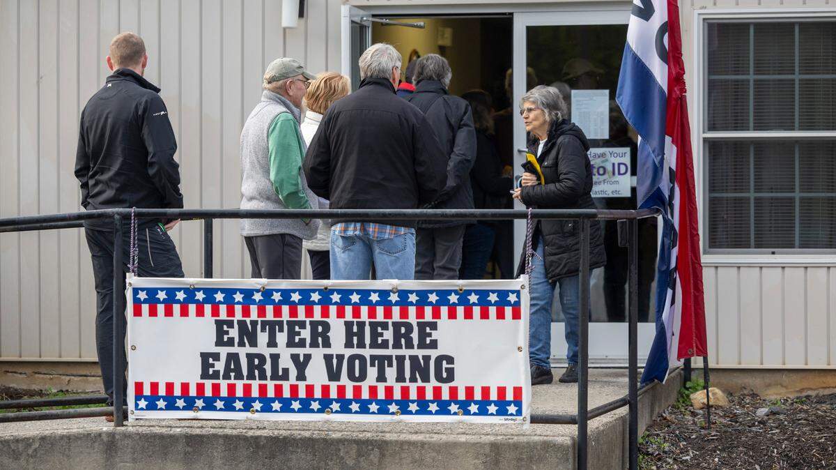 Voters wait in line to cast their ballots at the Haywood County Senior Resource Center, on the first day of early voting, in Waynesville, N.C. on Thursday, October 17, 2024.