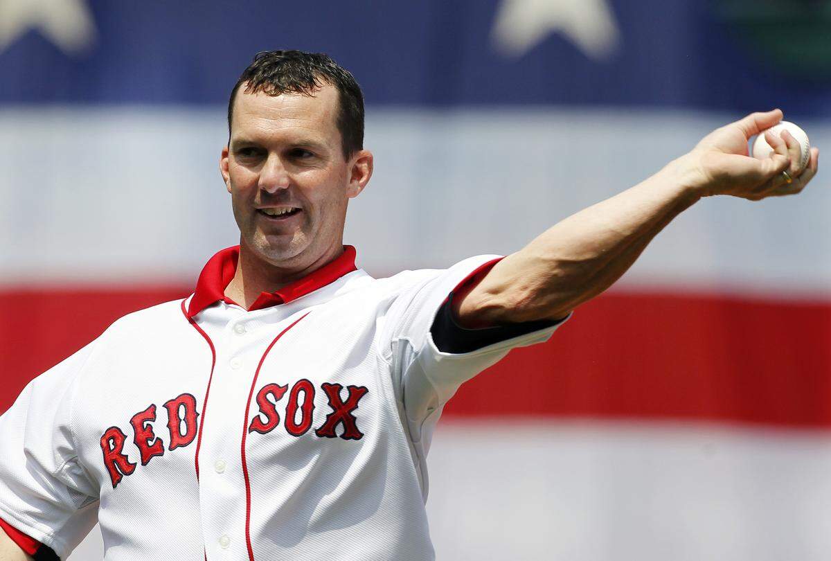 Former Boston Red Sox’s Trot Nixon throws out the first pitch before a baseball game between the Red Sox and the Detroit Tigers in Boston, Monday, May 28, 2012.