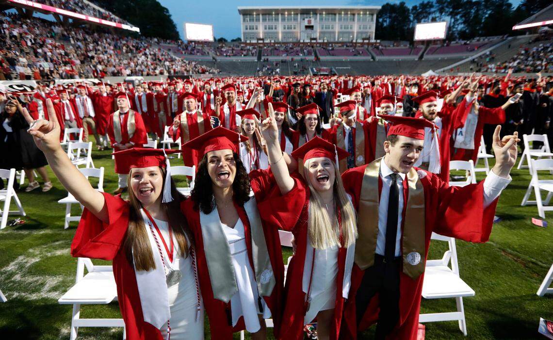 N.C. State graduates sing the alma mater during N.C. State’s commencement ceremonies for the class of 2021 at Carter-Finley Stadium in Raleigh, N.C., Friday, May 14, 2021.