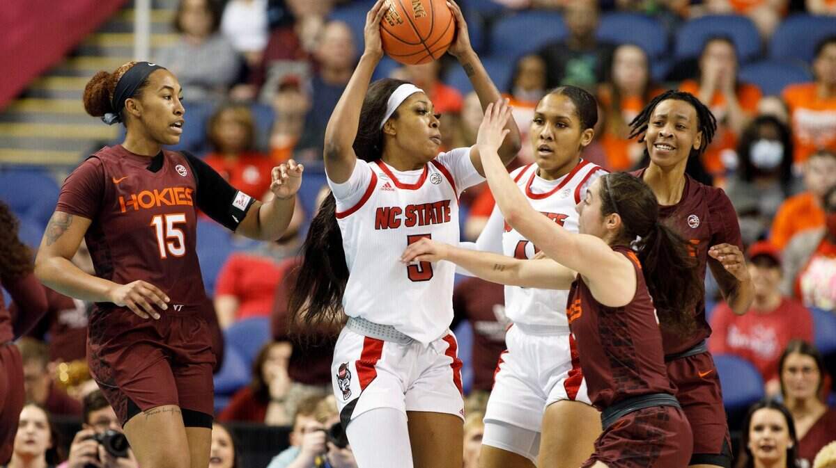 North Carolina State’s Jada Boyd (5) looks to pass the ball guarded by Virginia Tech’s Azana Baines (15) and Georgia Amoore (5) during the first half of an NCAA college basketball game in the semifinals of the Atlantic Coast Conference women’s tournament in Greensboro, N.C., Saturday, March 5, 2022. (AP Photo/Lynn Hey)