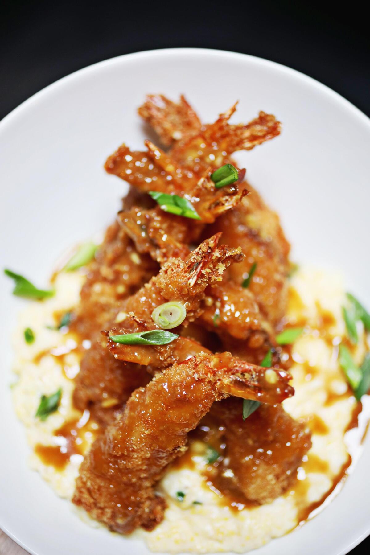 Scratch Kitchen & Taproom’s shrimp and grits is made up of tempura-battered shrimp with stone-ground cheese grits and a miso-ginger garlic sauce.