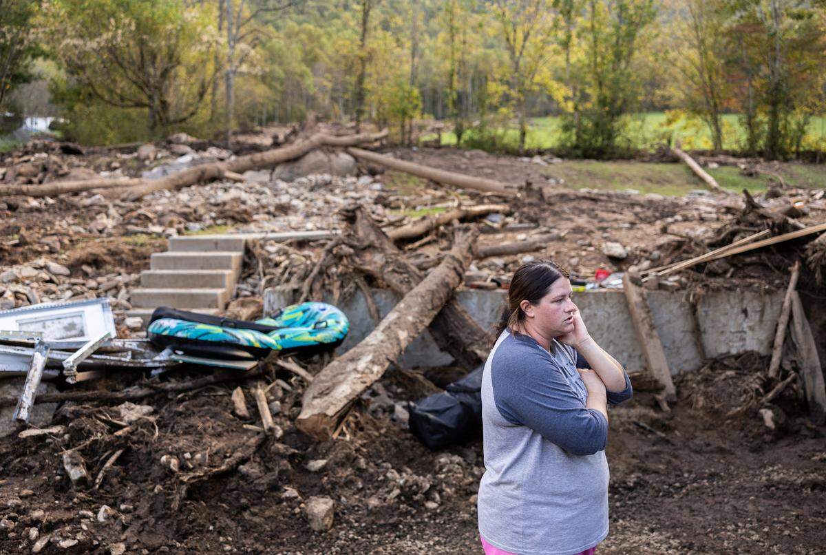 Kelli Ball stands in the area next to her home where a landslide came through in Barnardsville during Hurricane Helene.