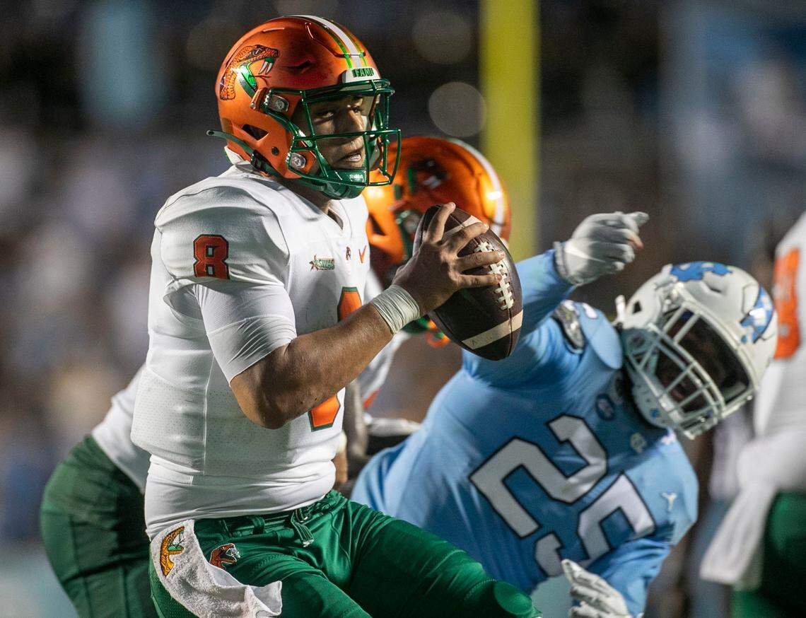 Florida A&M quarterback Jeremy Moussa (8) is pressured by North Carolinas Kaimon Rucker (25) in the fourth quarter on Saturday, August 27, 2022 at Kenan Stadium in Chapel Hill, N.C.