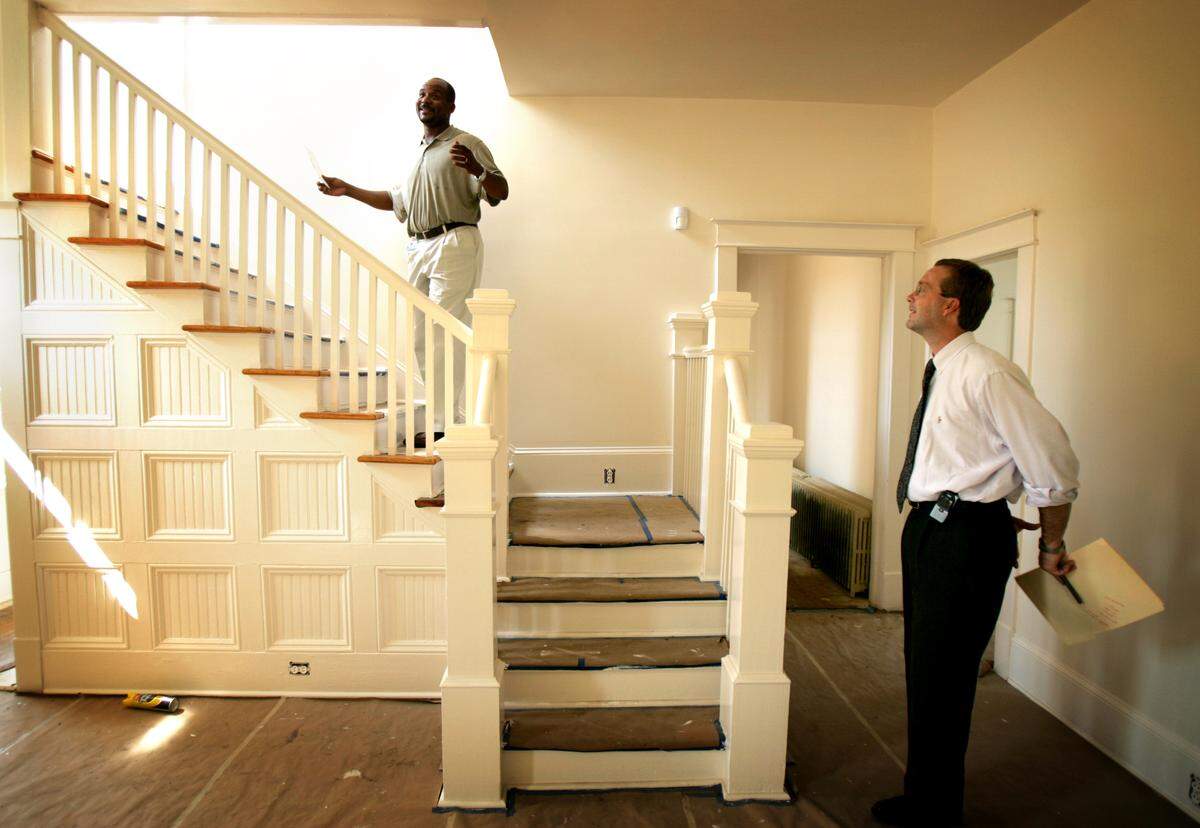 In this 2004 file photo, Jeff Moore, left, takes James Parajon on a tour of one of his properties in Southeast Raleigh that is part of his vision for Ligon Square, a community revitaliization project in memory of the late John Ligon.