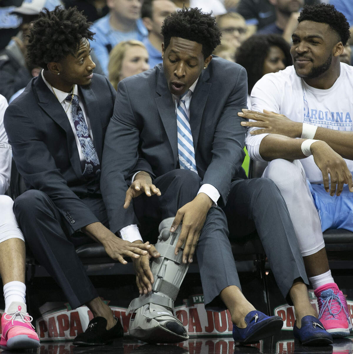 North Carolina’s Leaky Black, out with a sprained ankle and Sterling Manley, out with a knee injury, joke around on the bench during the closing minutes of the Tar Heels’ game against Louisville on Saturday, February 2, 2019 at the KFC Yum! Center in Louisville, Ky.