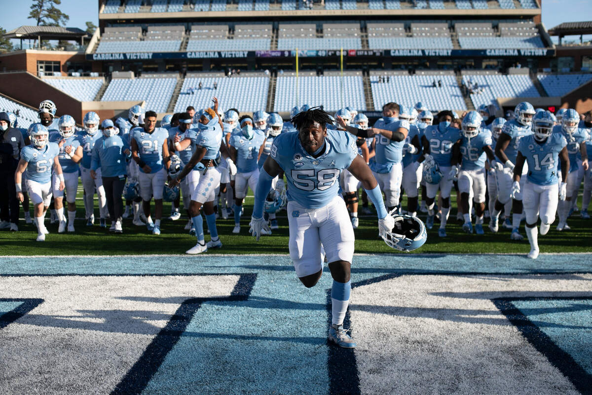 North Carolina’s Lancine Turay (58) leads the team off the field following the Tar Heel’s 49-9 victory over Western Carolina on Saturday, December 5, 2020 at Kenan Stadium in Chapel Hill, N.C.
