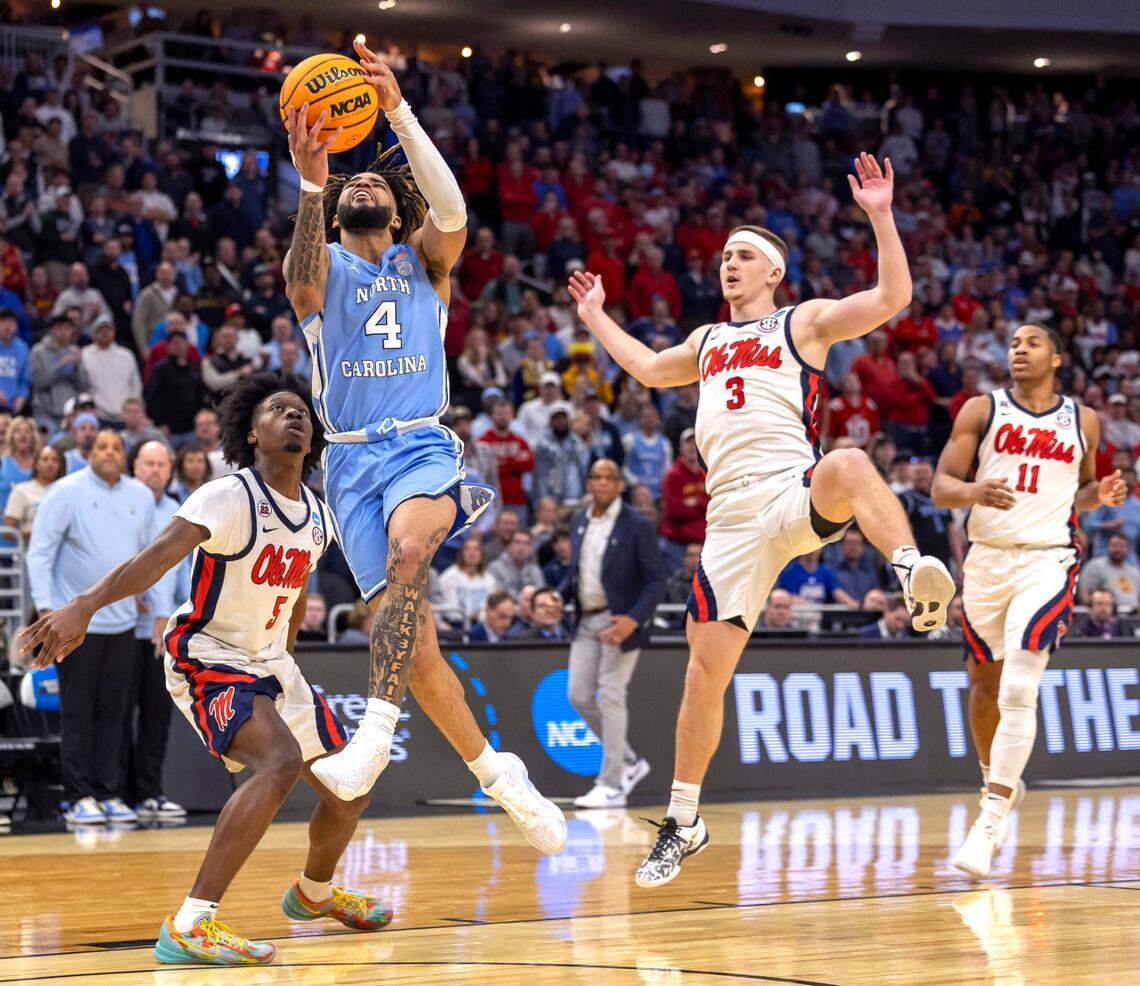 North Carolina guard R.J. Davis (4) breaks through the Ole Miss defense of Jaylen Murray (5) and Sean Pedulla (3) in the second half during the first round of the NCAA Tournament on Friday, March 21, 2025 at Fiserv Forum in Milwaukee, Wisconsin.