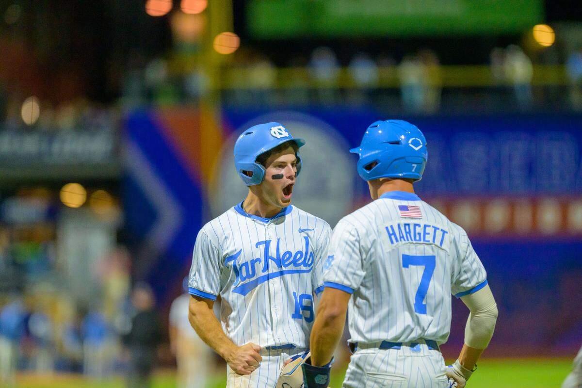 UNC left fielder Carter French celebrates with pinch hitter Perry Hargett during the Tar Heels’ 7-2 comeback win over Boston College in the ACC Tournament quarterfinals on Friday, May 23, 2025, at Durham Bulls Athletic Park in Durham, N.C.