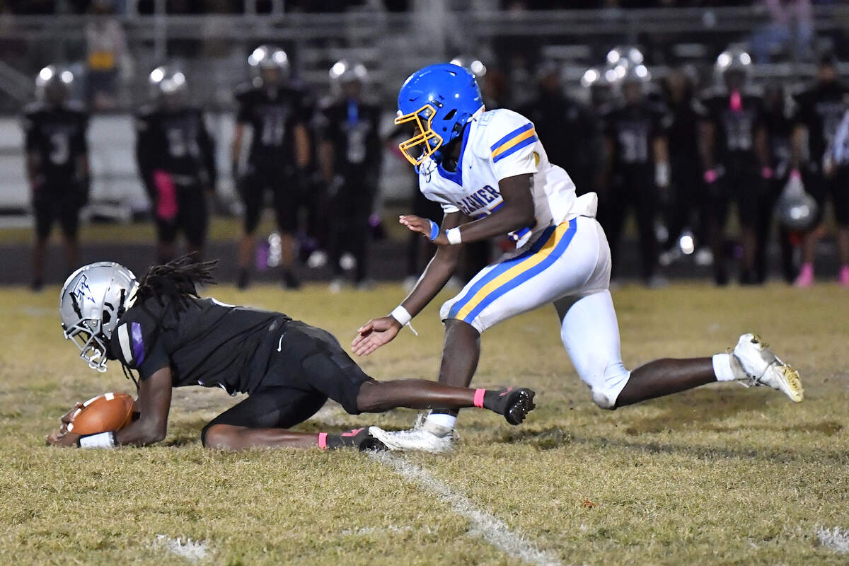 South Garner quarterback Chase Hardy (8) recovers the loose ball ahead of Garner linebacker Isaiah McFadden (25) during the second half. The South Garner Titans and the Garner Trojans met in a conference football game in Raleigh, N.C. October 17, 2025