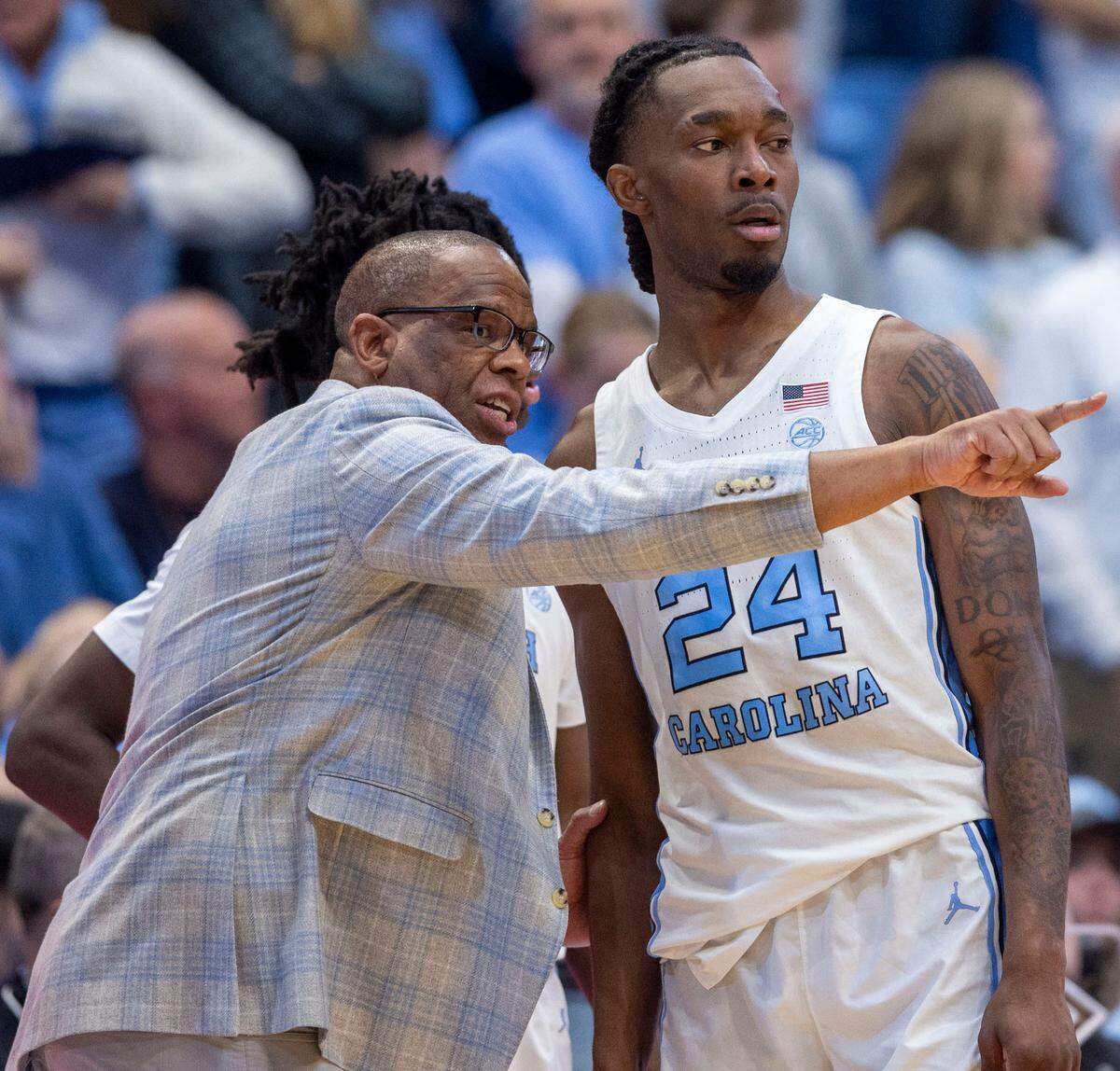 North Carolina coach Hubert Davis has a word with Jae’Lyn Withers (24) in the second half against Georgia Tech on Saturday, December 7, 2024 at the Smith Center in Chapel Hill, N.C.