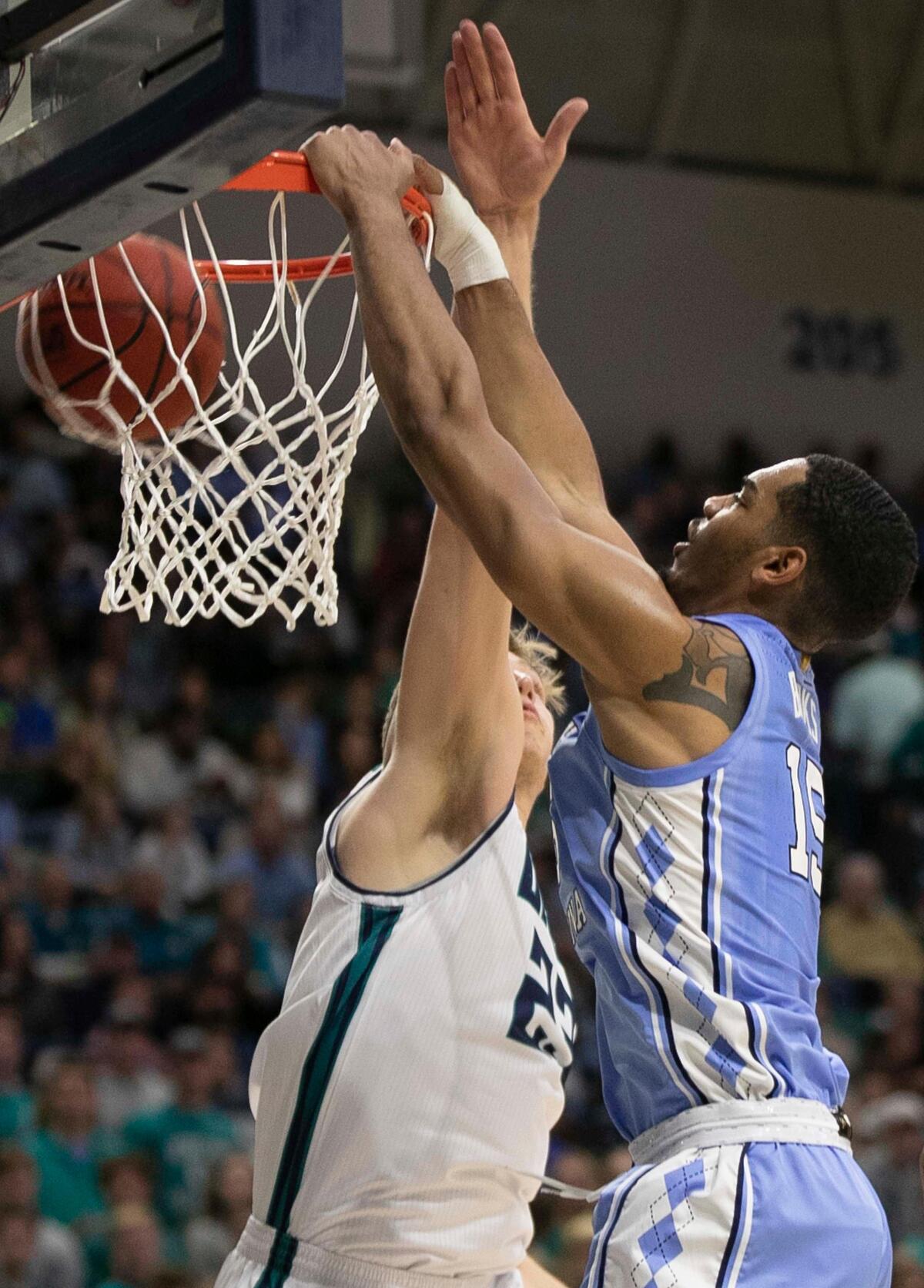 North Carolina’s Garrison Brooks (15) dunks over UNC-W’s Marten Linssen (23) during the first half on Friday, November 8, 2019 at Trask Coliseum in Wilmington, N.C.