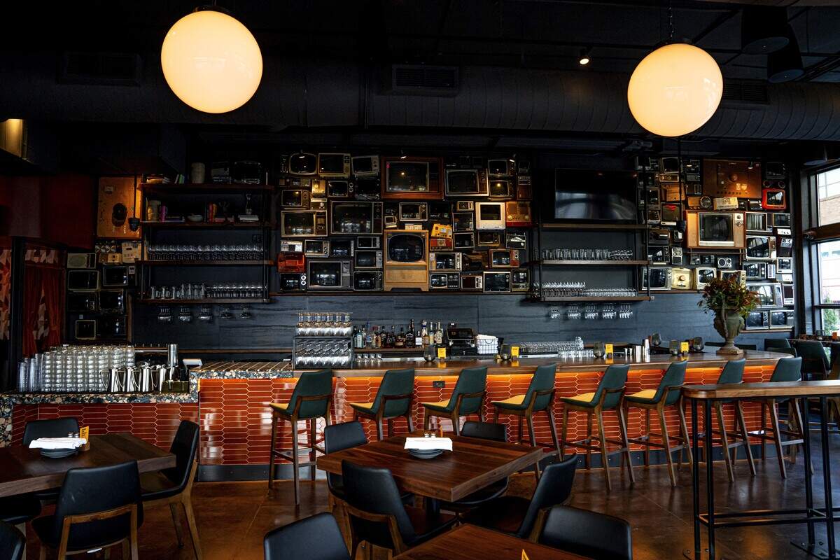 Chapel Hill’s Postino location will feature a custom liquor display and walnut wine walls, with booth seating and mid-century modern furnishings. The restaurant announced its move to University Place on South Estes Drive in June 2026.