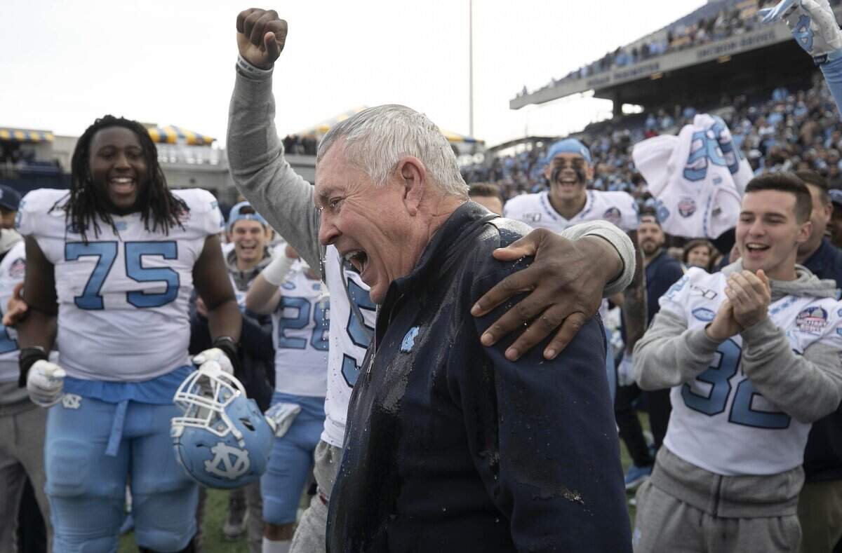 North Carolina players douse coach Mack Brown with water as they celebrate the Tar Heels’ 55-13 victory over Temple in the Military Bowl on Friday, December 27, 2019 at Navy-Marine Corps Memorial Stadium in Annapolis, Maryland.