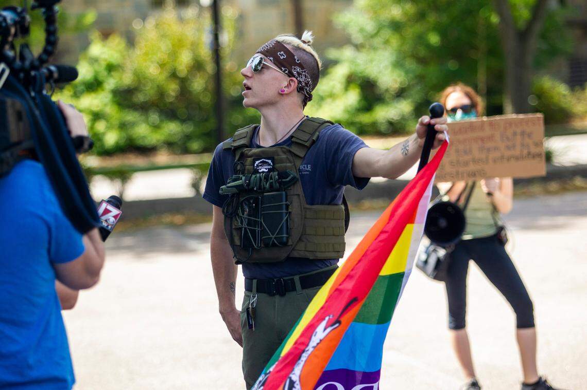 Benjamin Ryan Teeter is interviewed by television reporters as a group of about a half dozen mostly armed demonstrators affiliated with the Facebook group Blue Igloo prepared to march in downtown Raleigh Saturday, May, 16, 2020.