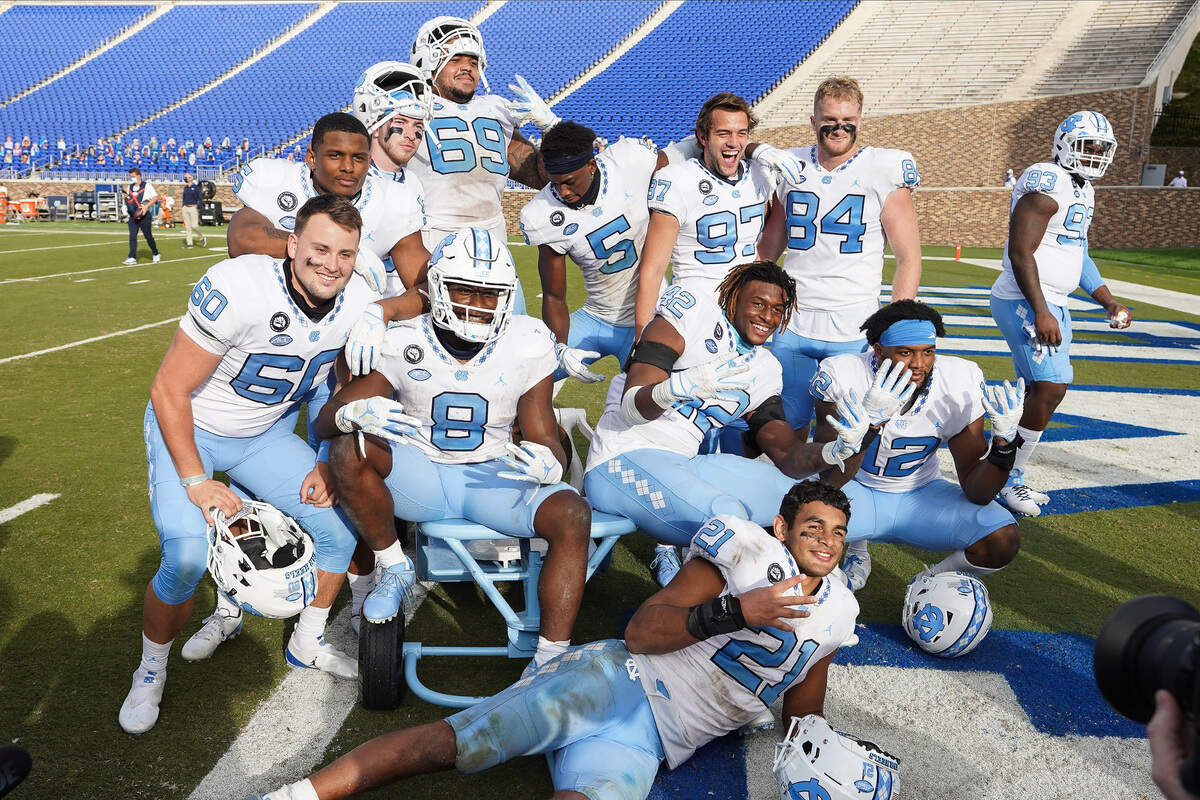 North Carolina Tar Heels players celebrate keeping the victory bell after their win over the Duke Blue Devils at Wallace Wade Stadium. 