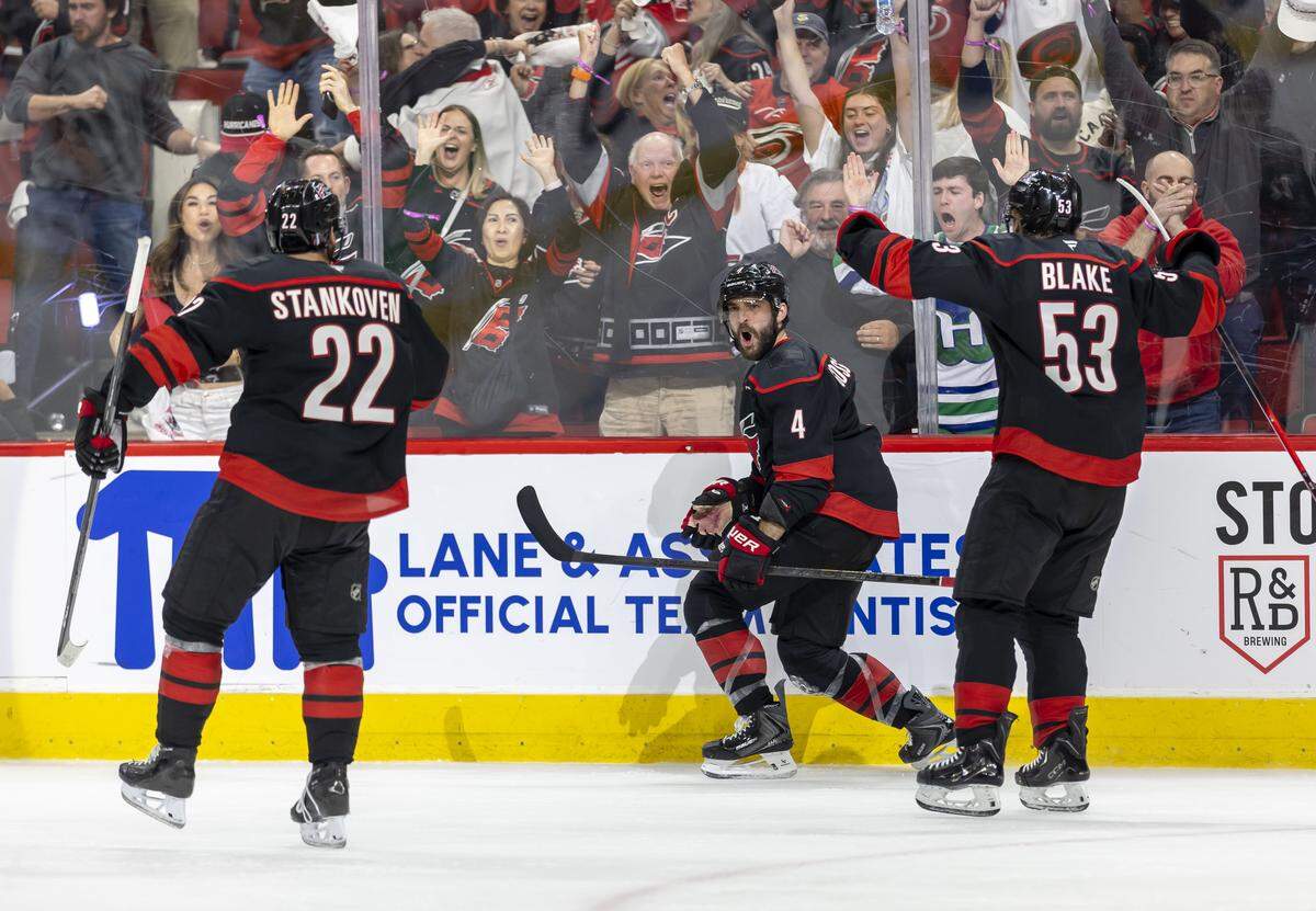 Carolina Hurricanes defenseman Shayne Gostisbehere (4) reacts with teammates Logan Stankoven (22) and Jackson Blake (53), after scoring to tie Las Vegas 4-4 in the third period of Game 1 in the Stanley Cup Finals, on Tuesday, June 2, 2026 at Lenovo Center in Raleigh, N.C.
