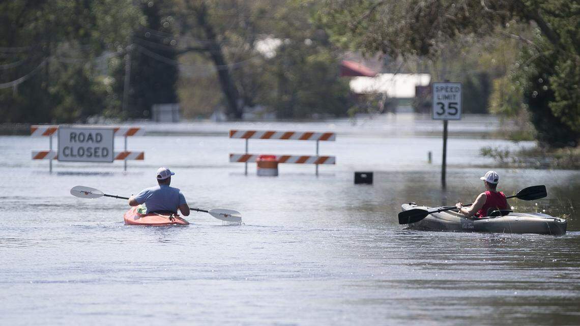 Two kayakers work to navigate the flooded Trent River on US17 on Tuesday, September 18, 2018 in Pollocksville, N.C. The Trent River is receding but local residents fear the bridge has been damaged beneath the swift moving flood waters. 