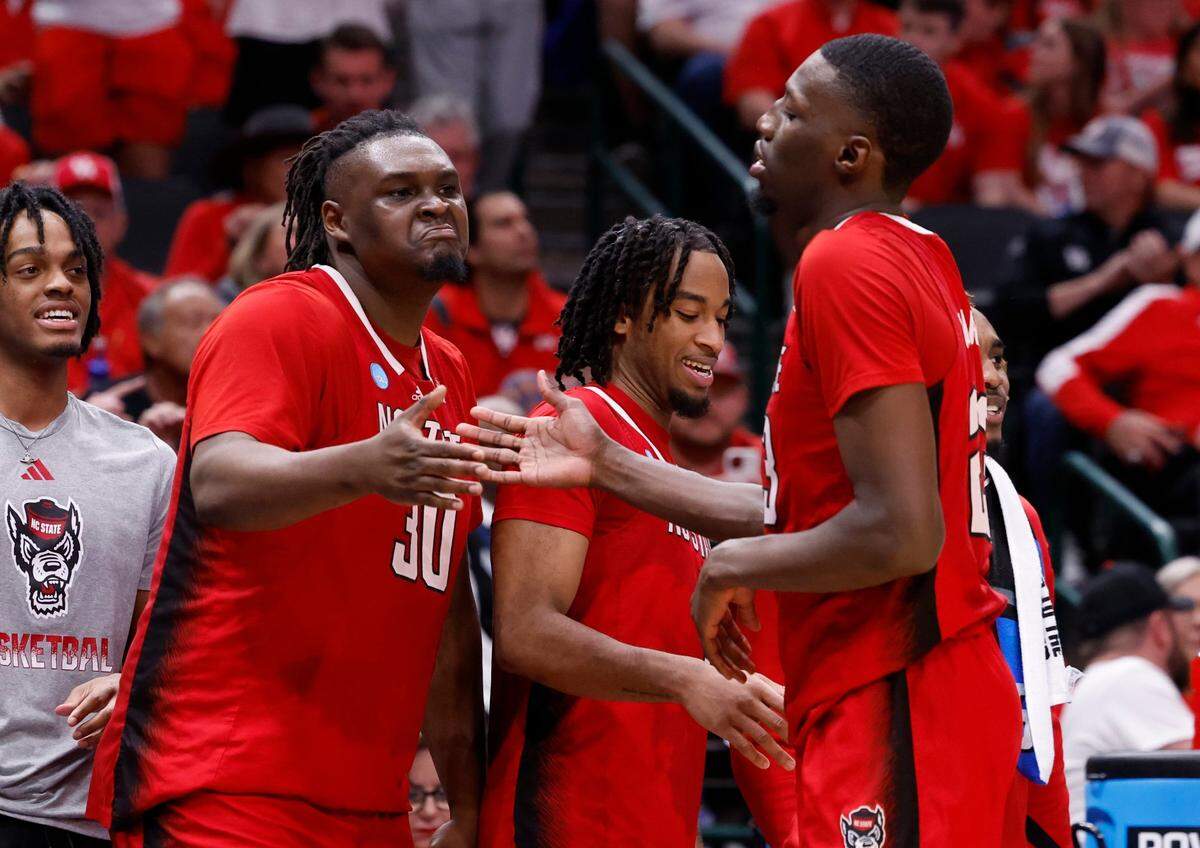 N.C. State’s DJ Burns Jr. (30) celebrates with Mohamed Diarra (23) as he comes off the court late in the second half of N.C. State’s 67-58 victory over Marquette in their NCAA Tournament Sweet 16 game at the American Airlines Center in Dallas, Texas, Friday, March 29, 2024.