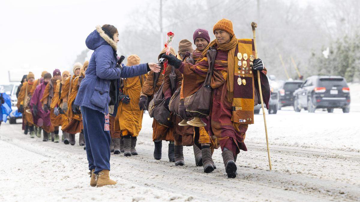 Despite winter weather conditions, a procession of Buddhist monks walks along Buffalo Road on Sunday, Jan. 25, 2026, in Raleigh. The monks are making a 2,300-mile pilgrimage from Texas to Washington, D.C., as part of the Walk for Peace, an effort to promote peace, compassion and national unity.