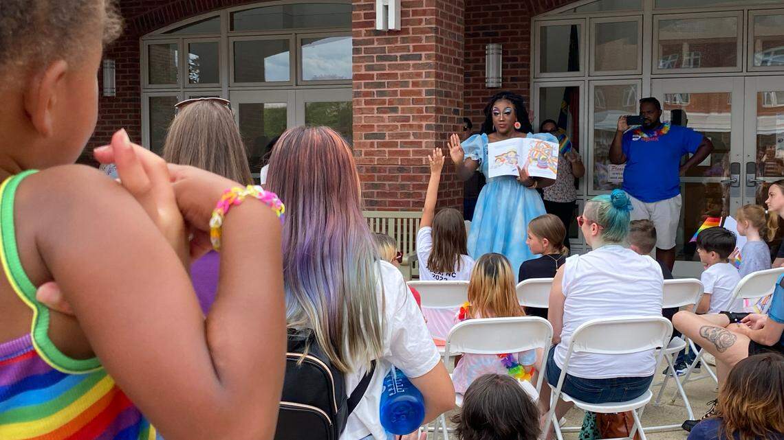 Drag queen “Stormie Daie” reads to children and parents at the Apex Pride Festival during Drag Queen Story Hour, Saturday, June 11, 2022.