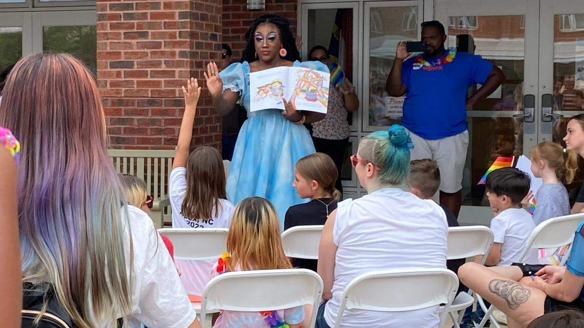 Drag queen Stormie Daye reads to children and parents at the Apex Pride Festival during Drag Queen Story Hour, Saturday, June 11, 2022.