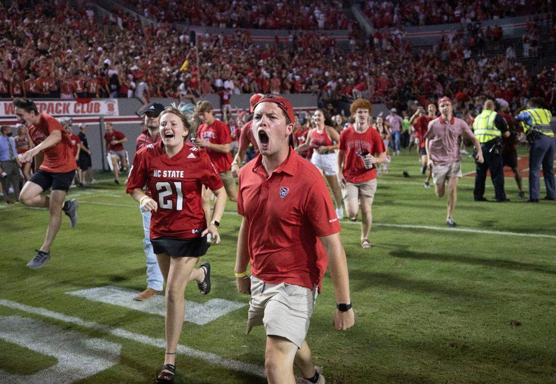 N.C. State fans storm the field to celebrate the Wolfpack’s 27-21 overtime victory over Clemson on Saturday September 25, 2021 at Carter-Finley Stadium in Raleigh, N.C.