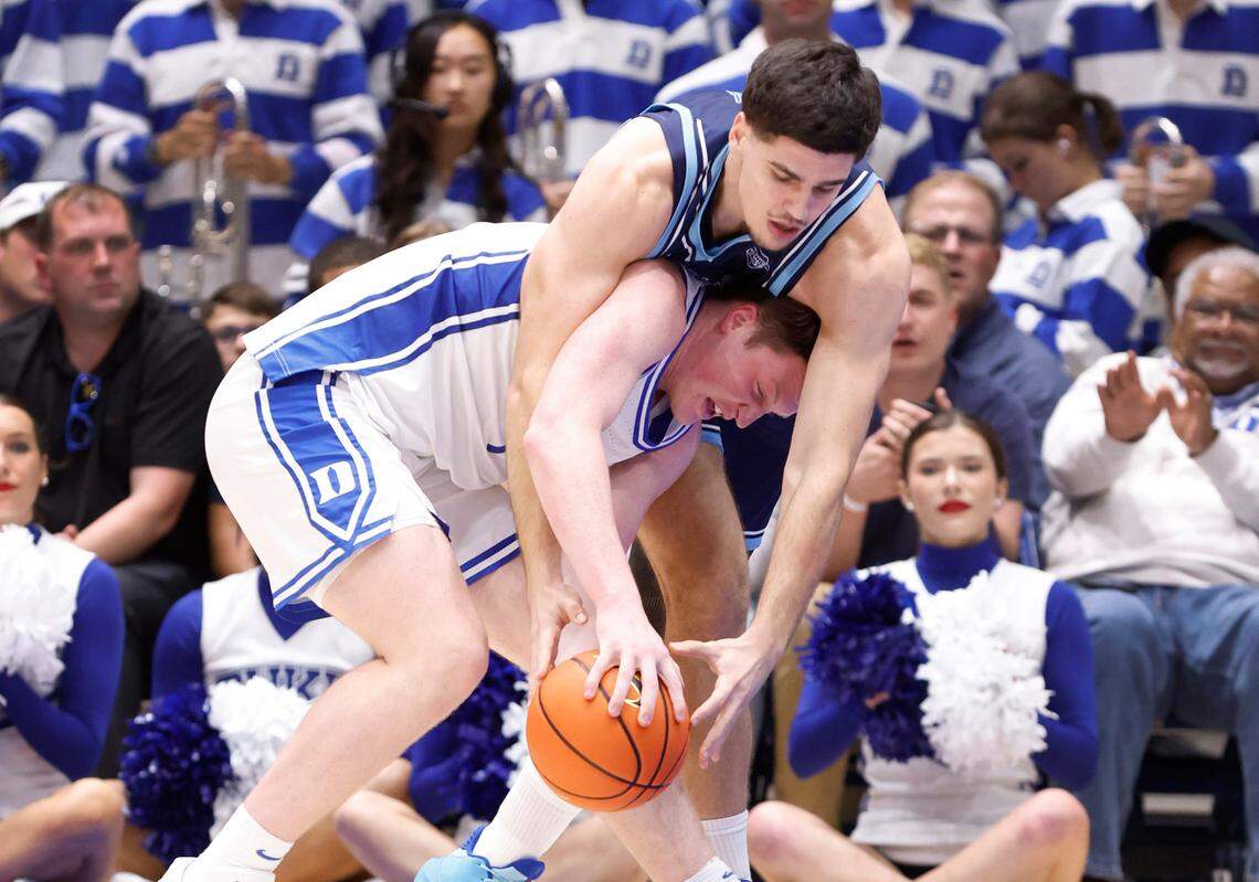 Duke’s Kon Knueppel (7) pulls the rebound from Maine’s Ridvan Tutic (11) during the second half of Duke’s 96-62 victory over Maine at Cameron Indoor Stadium in Durham, N.C., Monday, Nov. 4, 2024.