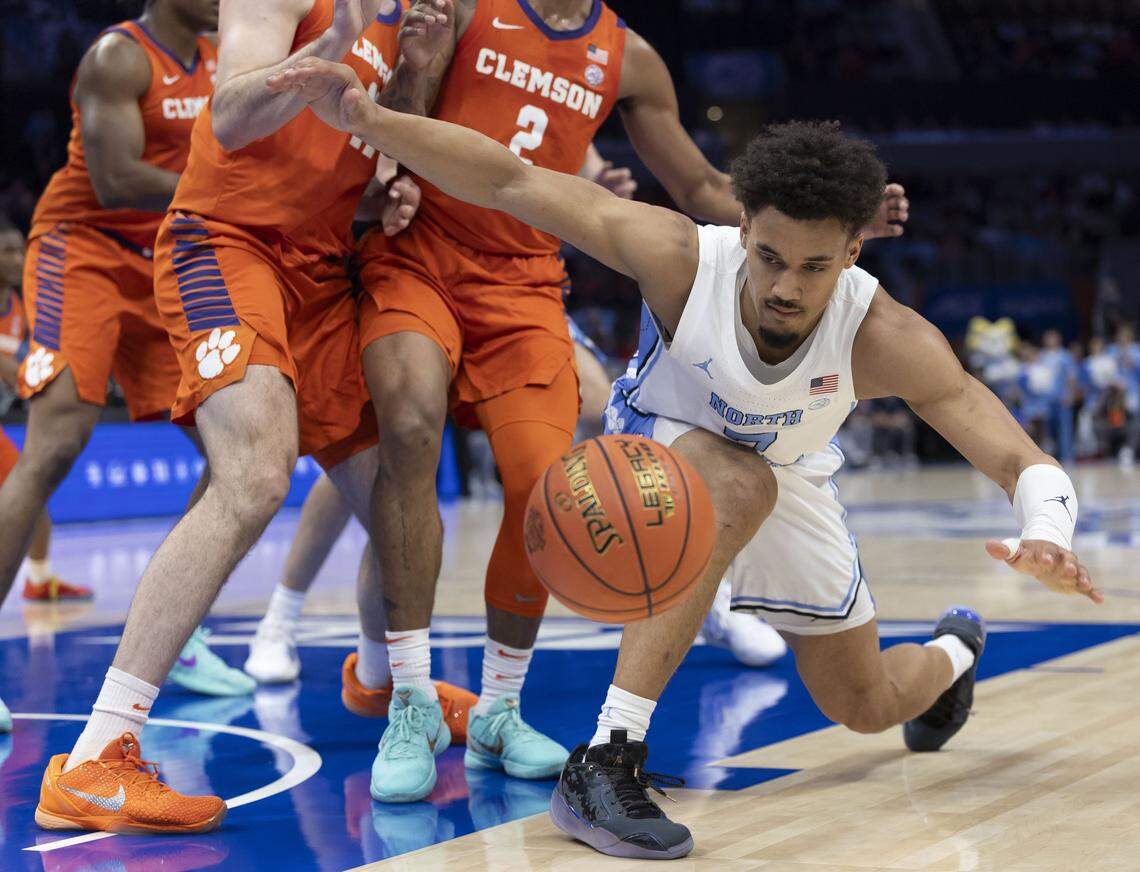 North Carolina guard Seth Trimble (7) fumbles the ball under pressure from the Clemson defense in the first half on Thursday, March 12, 2026, during the quarterfinals of the ACC Tournament at Spectrum Center in Charlotte, N.C.