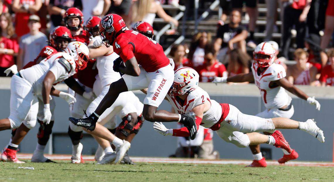 N.C. State wide receiver Porter Rooks (4) pulls in the reception in front of Virginia Military Institute linebacker Evan Eller (2) during the second half of the Wolfpack’s 45-7 victory over VMI at Carter-Finley Stadium in Raleigh, N.C., Saturday, Sept. 16, 2023.